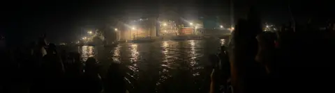 The ghats of Varanasi at night, lamps along the river